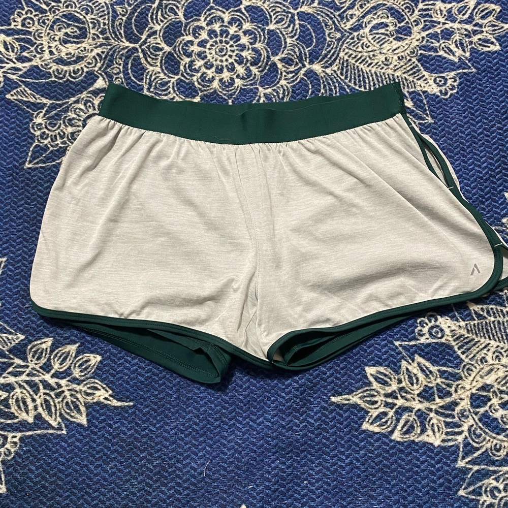 Athletic shorts with spandex under layer